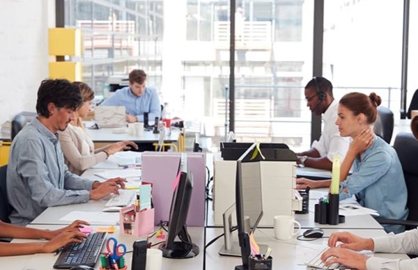 workers in an open plan work space workers in an open plan work space